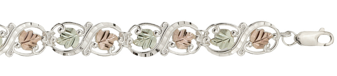 Sterling silver infinity link bracelet with hand sculptured grape leaves, close up.