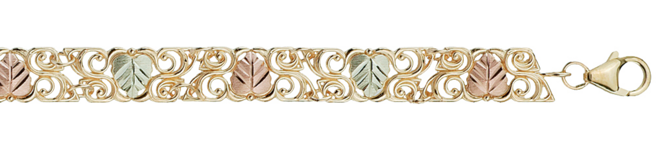 10k yellow gold filigree embracing 12k pink gold and green gold grape leaf bracelet.