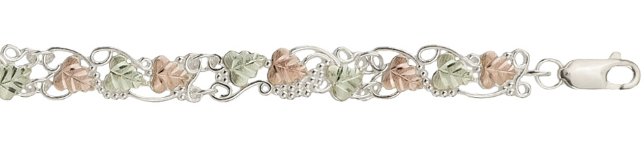 Sterling silver filigree grape vine bracelet with grape leaves and grape clusters, close up.