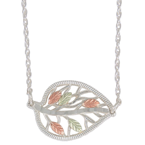 Sideways leaf necklace in sterling silver, 12k red gold, 12k green gold.