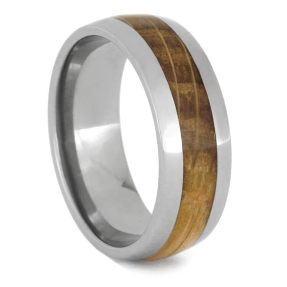 Call the shots with this whiskey barrel oak wood wedding band. This titanium wedding band is inlaid with oak wood from an authentic whiskey barrel from Tennessee. It’s made with a round profile and an exceptionally comfortable sleeve.