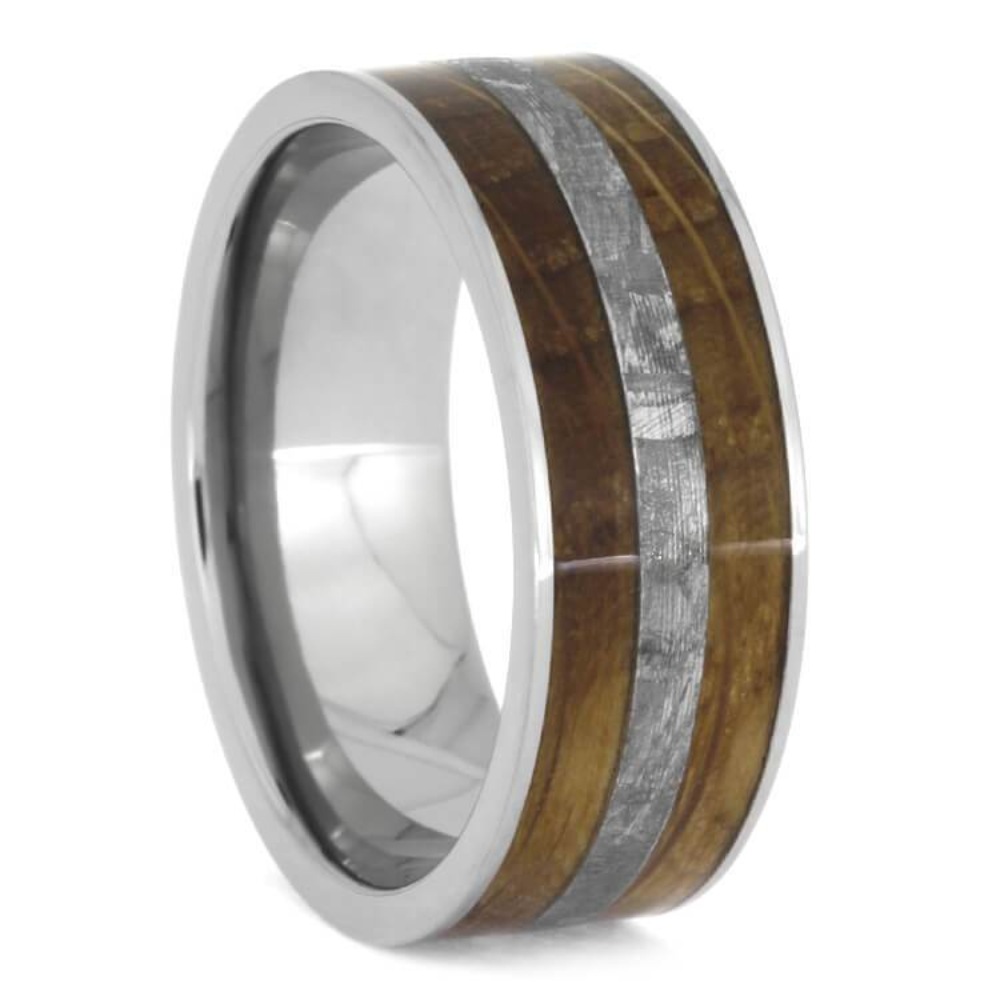 Star-crossed Gibeon meteorite divides the rich wood on this whiskey oak titanium ring. Oak wood from a genuine whiskey aging barrel is inlaid on the durable titanium sleeve. This handmade jewelry makes an excellent gift for a whiskey connoisseur or astronomy enthusiast.