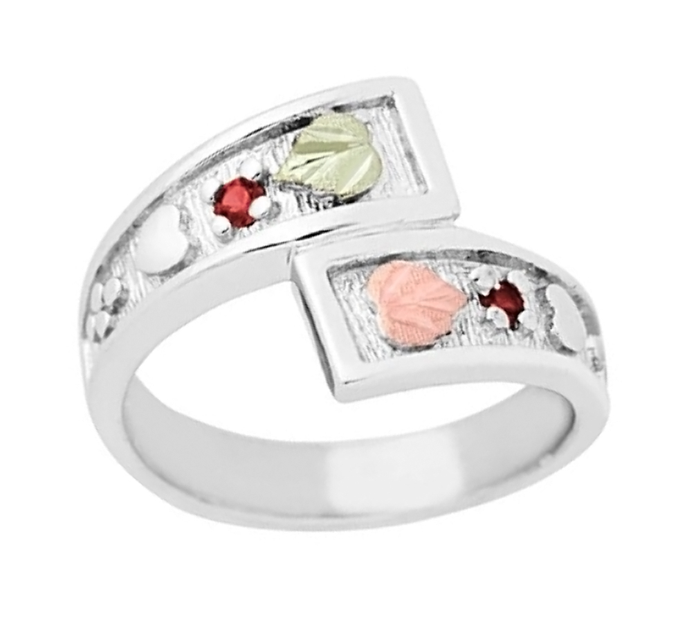 Created garnet January birthstone bypass ring crafted in hypoallergenic, polished, rhodium plated sterling silver.